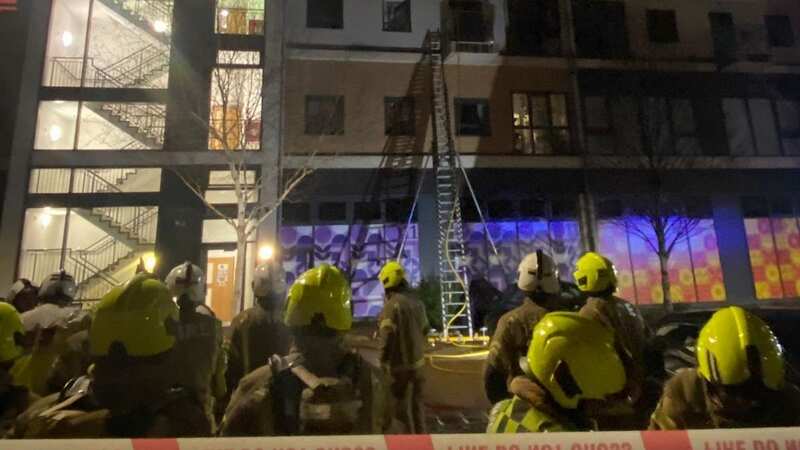 Firefighters were seen climbing up to the third floor to rescue to the woman from the west London flat (Image: London Fire Brigade)