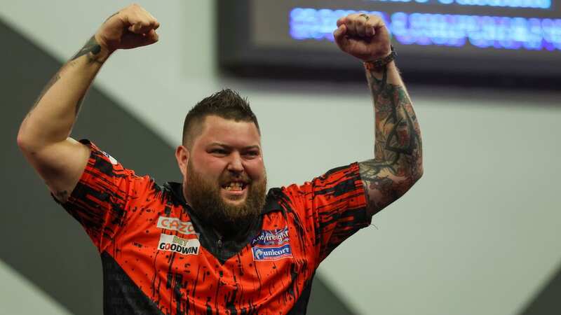 Michael Smith celebrates winning the PDC World Darts Championship and £500,000 in prize money (Image: PA)