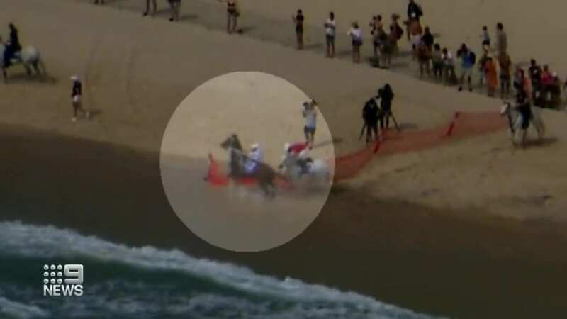 The moment one of the horses spooks at the sea, resulting in two riders coming off (Image: @9NewsGoldCoast/Twitter)