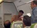 Topless thug brawls with another passenger on packed plane in row over seats qhiqquiqxeidexinv