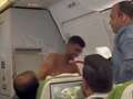 Topless thug brawls with another passenger on packed plane in row over seats eiqrtiquqiqerinv