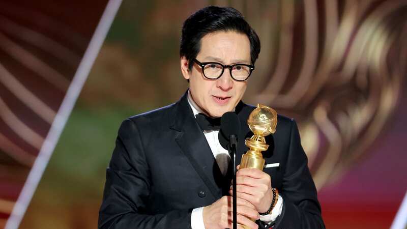 Ke Huy Quan speaks onstage at the Golden Globes (Image: Getty Images)