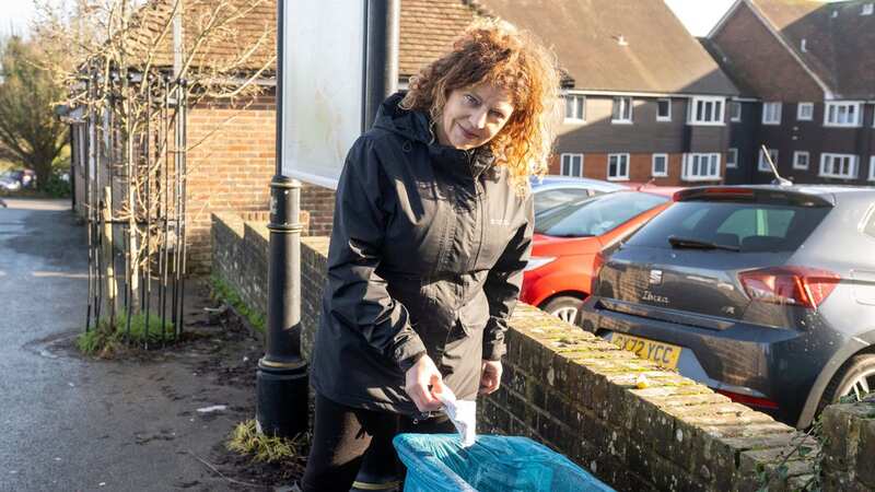 Olivia Post by the bin near her home she was fined for using (Image: SWNS)