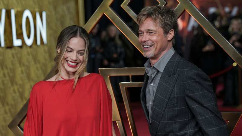 Margot Robbie and Brad Pitt beam as they greet each other at Babylon UK premiere