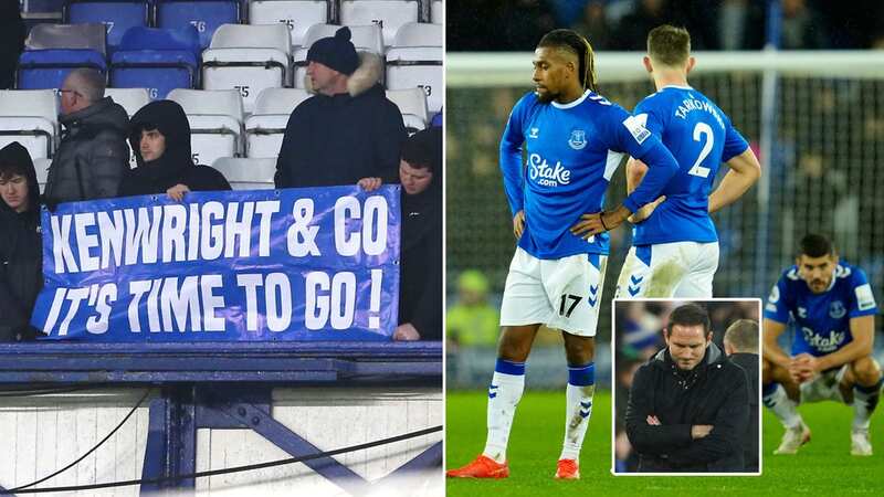 Everton fans hold up banners in protest against the club
