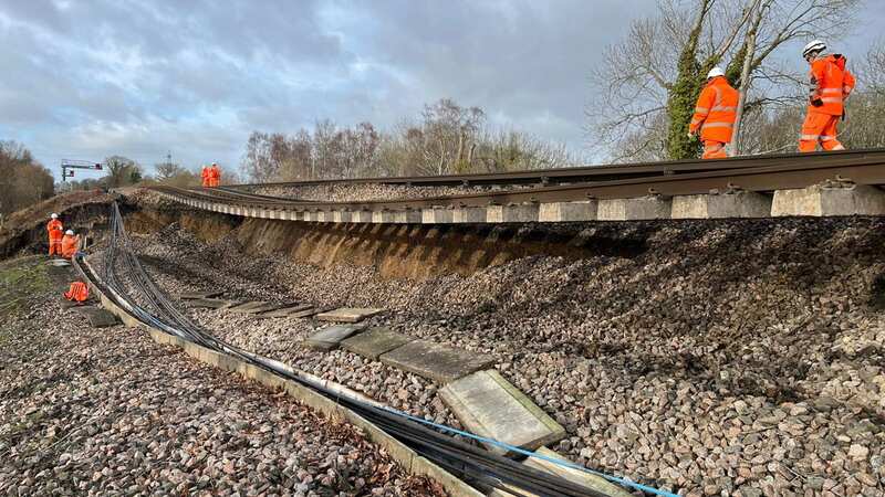 Huge landslip hits rail line leaving track hanging in mid air