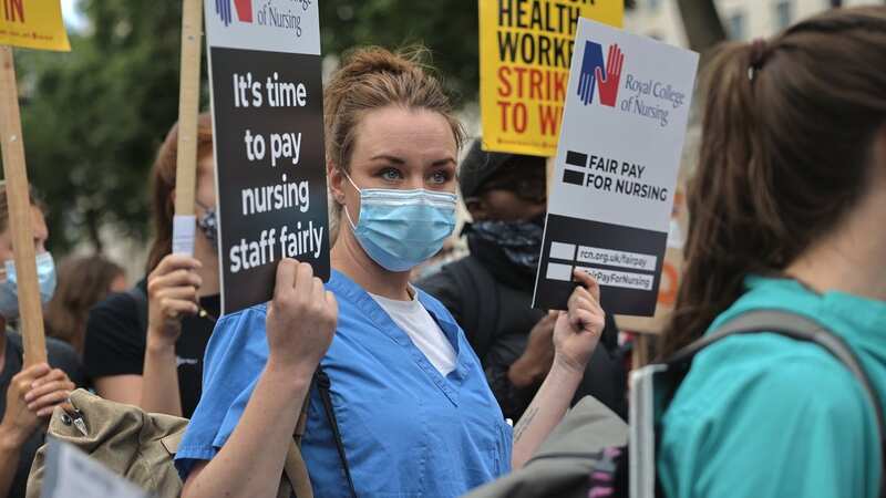 A nurse holds a placard demanding fair pay rise from the government for healthcare staff (Image: SOPA Images/LightRocket via Getty Images)