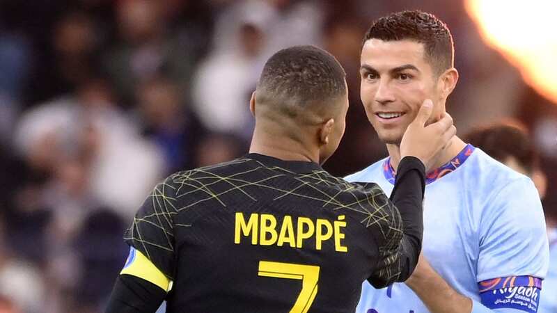 Kylian Mbappe and Cristiano Ronaldo speak during PSG