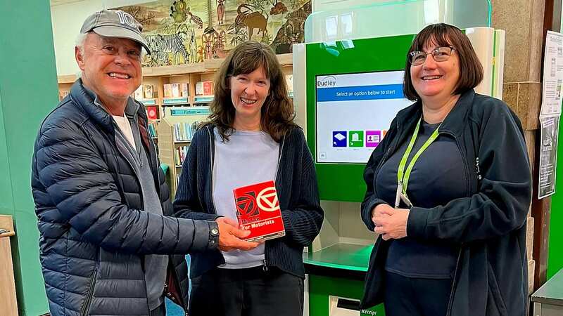 David Hickman returning the book to Dudley Library (Image: GLL / SWNS)