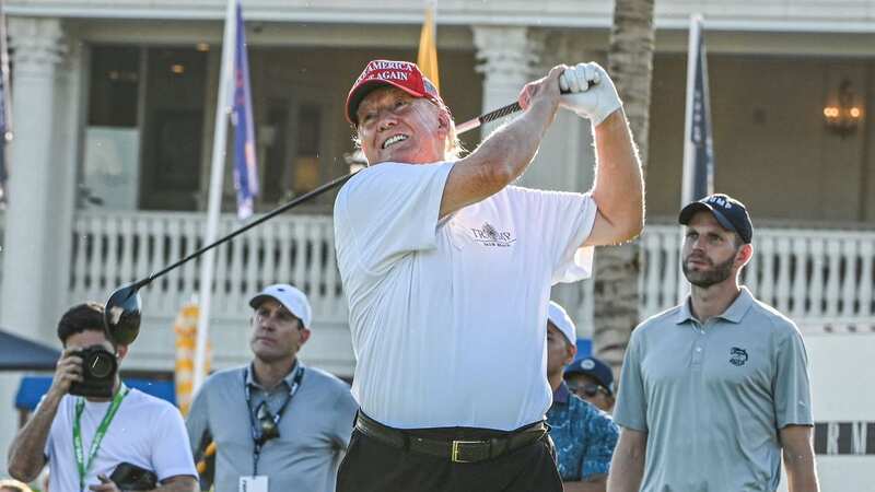 Former US President Donald Trump tees off (Image: AFP via Getty Images)