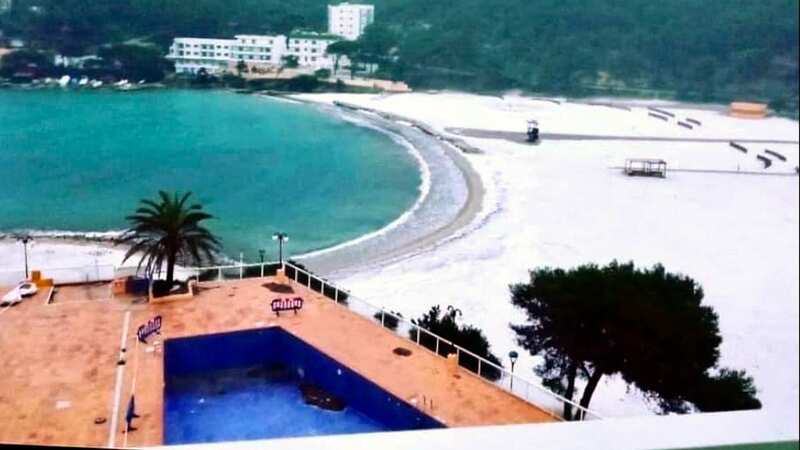 Usually known for its blue skies and sun, the beaches of Ibiza were covered in snow this week (Image: SOLARPIX.COM)