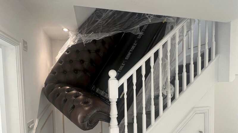 The sofa stuck on the stairs (Image: Luke Harry Ansell / SWNS)
