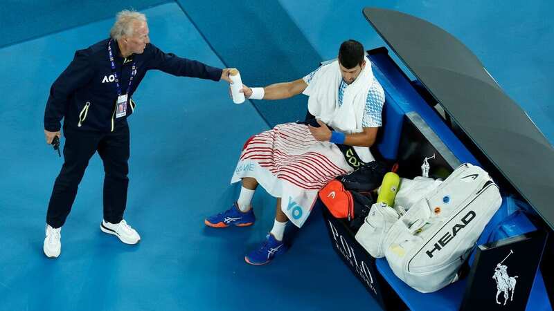 Novak Djokovic appeared to read a note which was attached to a suspicious white bottle passed to him (Image: Darrian Traynor/Getty Images)