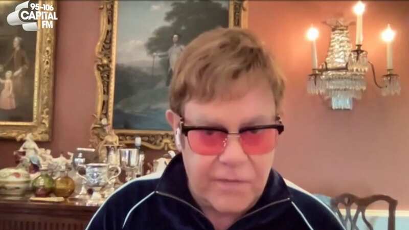 Elton John awkwardly 