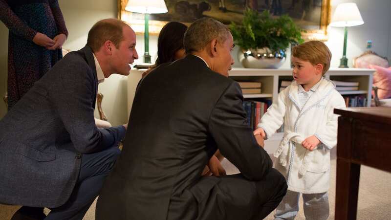 Prince George, dressed in his pyjamas and dressing gown, meets Barack Obama in 2016 (Image: Getty Images)