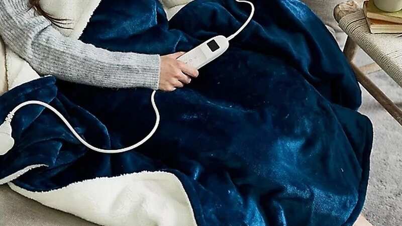 The heated throw from Lakeland costs 1p per night to run (Image: Geoffrey Swaine/REX/Shutterstock)