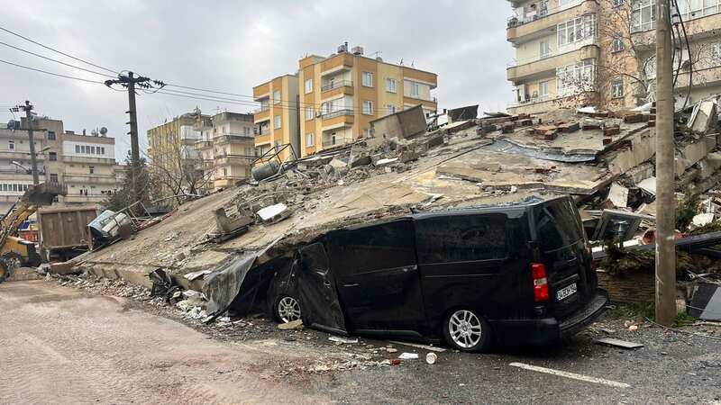 A van under a collapsed building in Sanliurfa, Turkey (Image: PA)