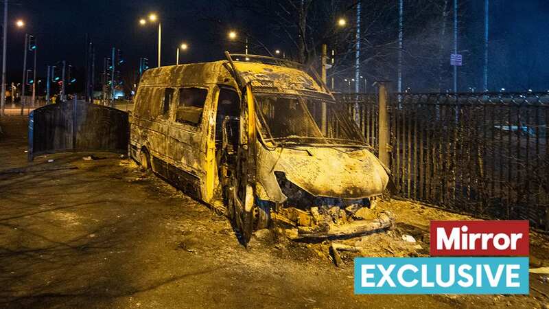 A burnt police van after a demonstration outside the Suites Hotel in Knowsley (Image: PA)