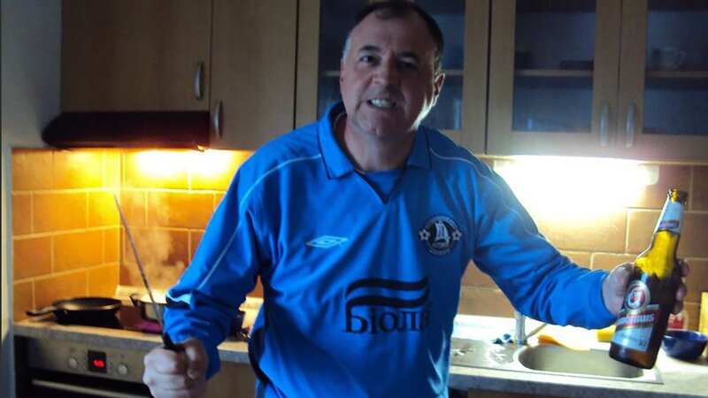 David Smith wearing FC Dnipro jersey and posing for a photo with a knife and a beer (Image: EAST2WEST NEWS)