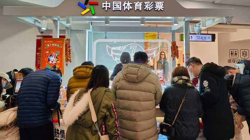 People buy tickets at the China Sports Lottery counter in Shanghai, China (Image: Future Publishing via Getty Images)