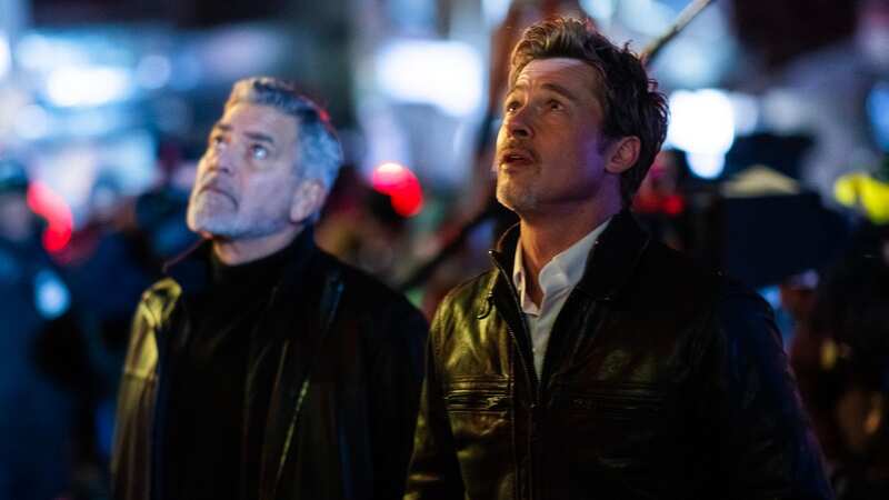 Brad Pitt and George Clooney twin in stylish leather jackets on movie set