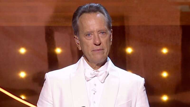BAFTA host Richard E Grant stopped to compose himself as he took a moment to remember those the industry lost in the last 12 months (Image: BBC, Getty)
