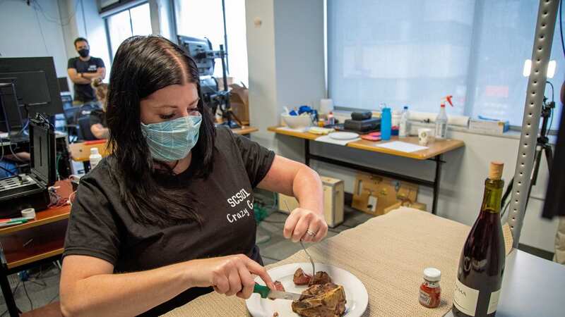 Heather cuts a steak after pioneering treatment saw her move her arm for the first time in almost 10 years (Image: PA)