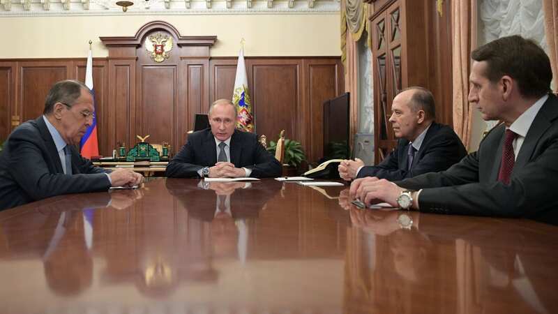 Russian President Vladimir Putin speaks with Foreign Minister, Sergei Lavrov and director of the Foreign Intelligence Service, Sergei Naryshkin (Image: AFP/Getty Images)