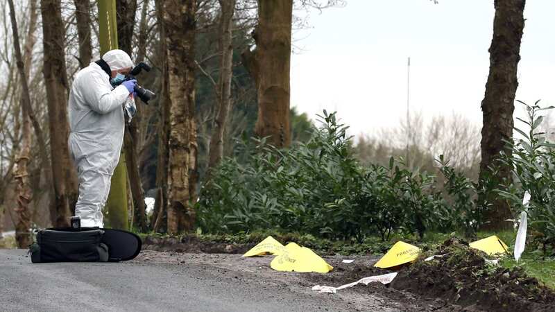 A forensic officer at the scene near the sports complex in the Killyclogher Road area of Omagh, Co Tyrone, where off-duty PSNI Detective Chief Inspector John Caldwell was shot a number of times by masked men (Image: PA)