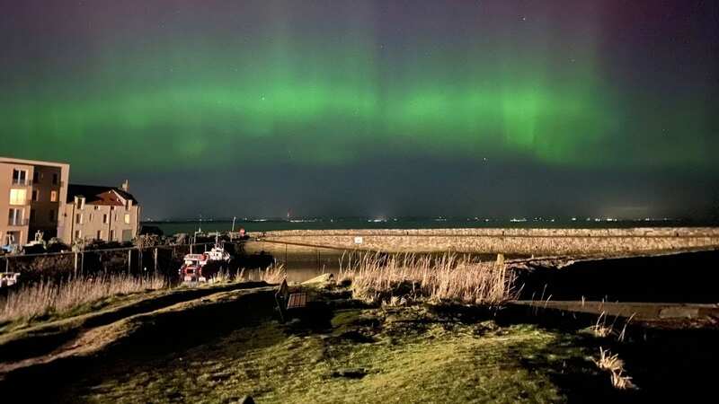 The Northern Lights over St Andrews in Scotland (Image: PA)