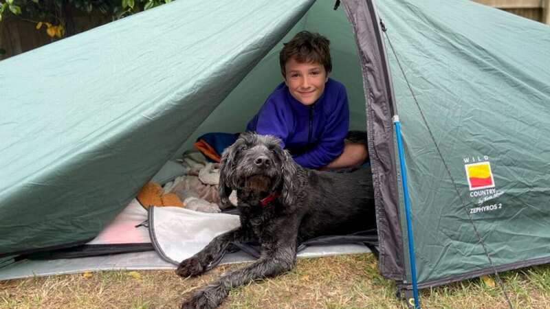 Max Woosey camping out in his tent in his garden in Braunton, Devon (Image: Woosey Family / SWNS.COM)
