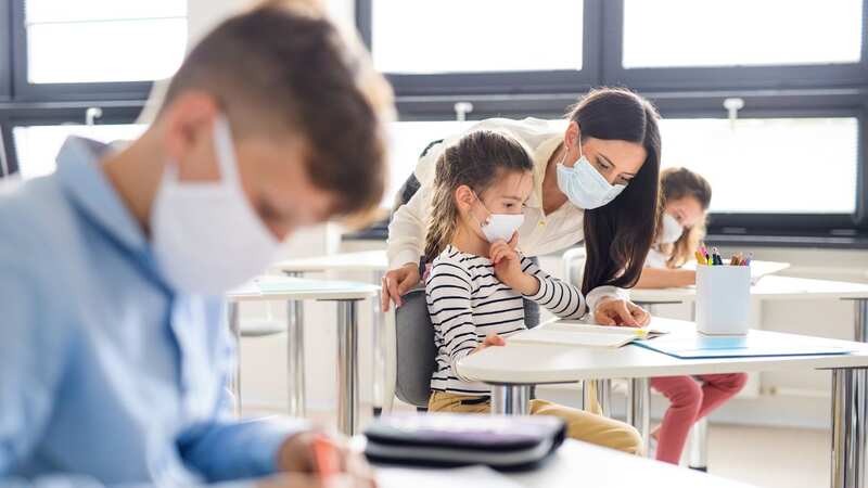 Group of children with face masks back at school (Image: Getty Images/iStockphoto)