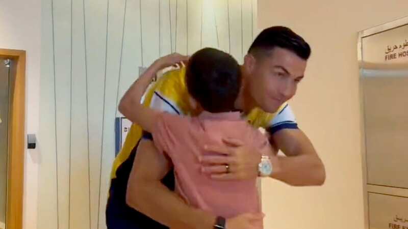Cristiano Ronaldo embraces a young fan