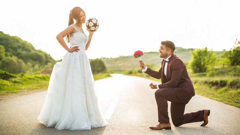 Both the happy couple are huge football fans (stock photo) (Image: Getty Images/iStockphoto)