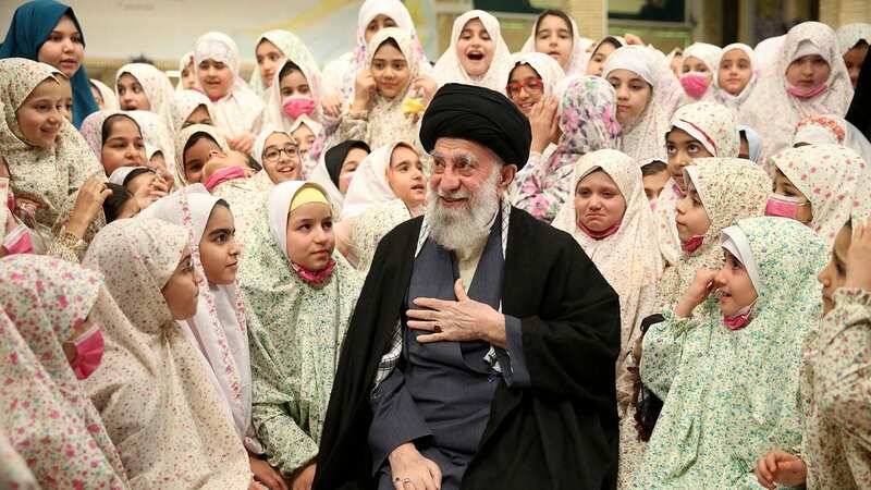 Supreme Leader Ayatollah Ali Khamenei talking with Iranian girls (Image: KHAMENEI.IR/AFP via Getty Images)