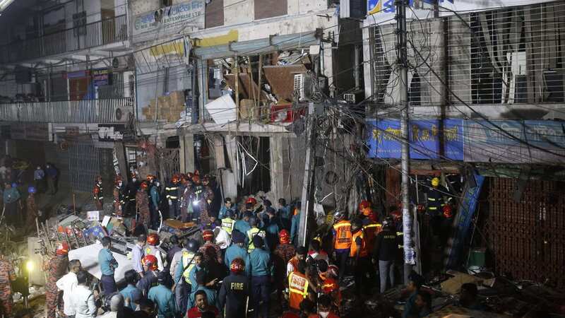 Firefighters and emergency teams works amidst debris following an explosion inside building in Dhaka (Image: AFP via Getty Images)