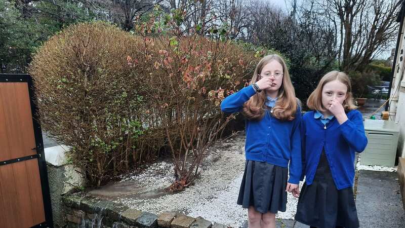 Morven (left) and Madeleine Smyth are left pinching their noses due to the foul waste swamping their home (Image: Louise Morgan)