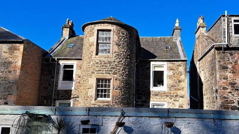 This Victorian attic flat in a seaside town is on an idyllic Scottish island (Image: Auction House Scotland / SWNS)