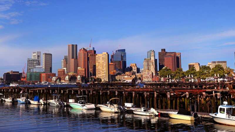 Boston, MA - August 12: A view of boats lined up at a marina on the East Boston side with the City of Boston across the harbor in the early morning. (Photo by David L. Ryan/The Boston Globe via Getty Images)