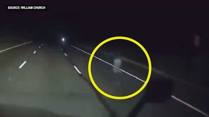 Moment creepy ghost-like figure spotted on road while trucker drives alone