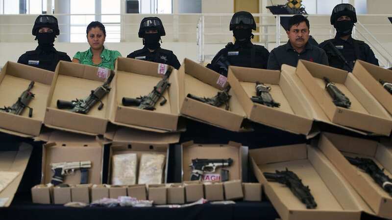 Members of drug gang "Los Zetas" are shown off by police along with a massive haul of weapons (Image: AFP via Getty Images)