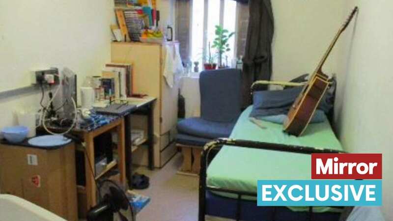 A photo taken inside a cell at HMP Garth in Lancashire shows a guitar, a TV and a laptop
