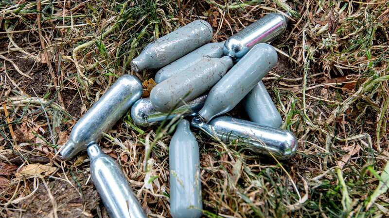 Cannisters of laughing gas laying in the grass (Image: SWNS)