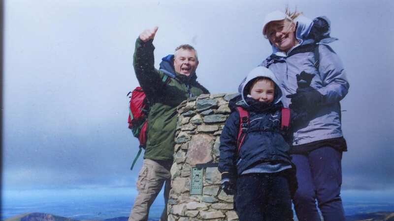 Charlie with his proud parents at the top of Yr Wyddfa (formerly Snowdon) (Image: Paul Batham / SWNS)