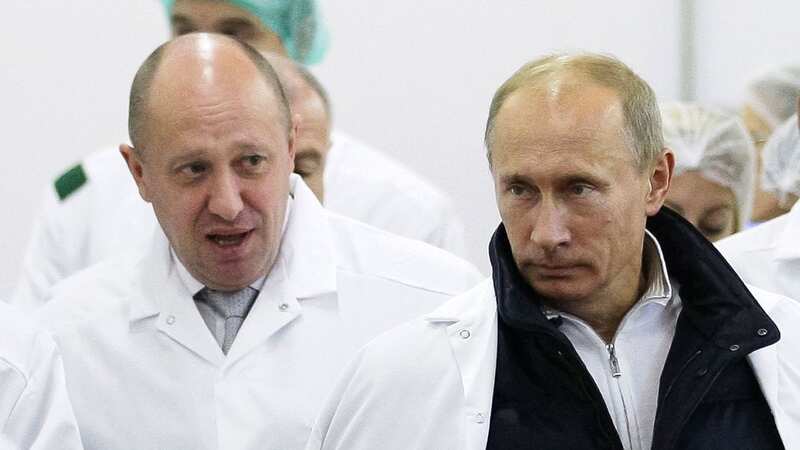 Yevgeny Prigozhin, left, with Russian President Vladimir Putin (Image: Uncredited/AP/REX/Shutterstock)