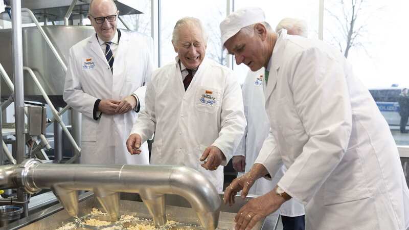 King Charles was seen laughing as he tried to make cheese (Image: Daily Mirror/Ian Vogler)