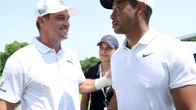 Bryson DeChambeau talks with Tiger Woods