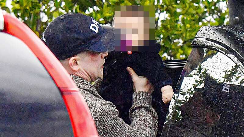 Macaulay was seen with his baby son (Image: @CelebCandidly / MEGA)