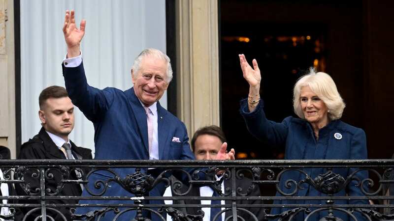 King Charles and Camilla wave from the balcony of Hamburg City Hall on March 31 (Image: Daniel Reinhardt/picture-alliance/dpa/AP Images)