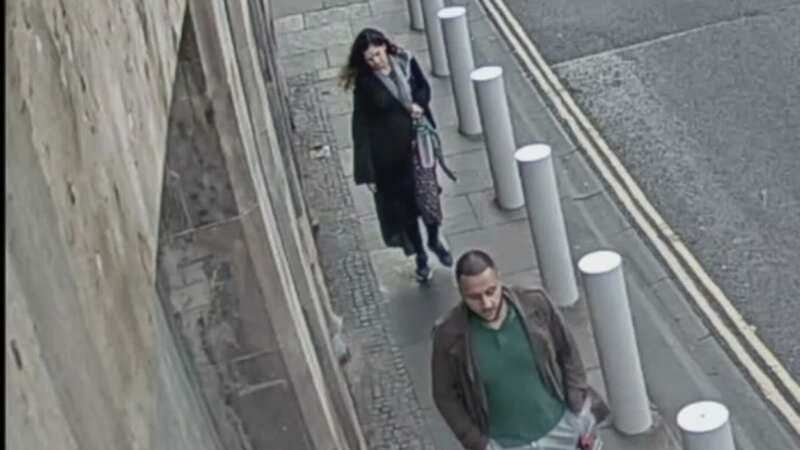 Kashif Anwar, 29, from Leeds (front) followed by his wife Fawziyah Javed, 31, at 7.10pm on High St at the Scottish Parliament in Edinburgh (Image: PA)